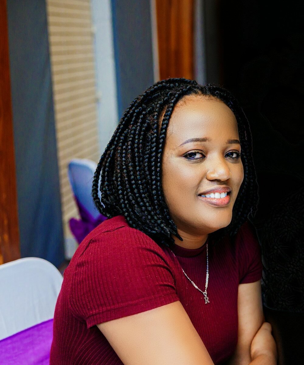 woman in red shirt wearing white and black knit cap