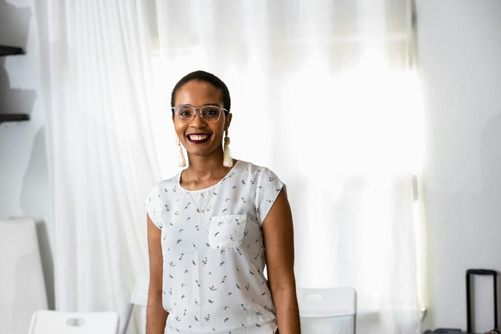 user3-free-img a woman standing in front of a window smiling